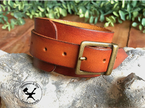 cognac leather cuff bracelet with a handstitched strap and bronze colored buckle
