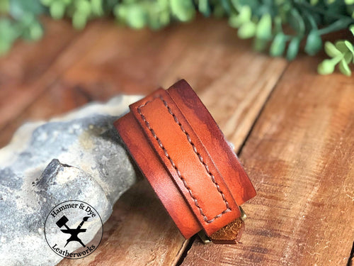 Brown leather cuff bracelet with a handstitched strap