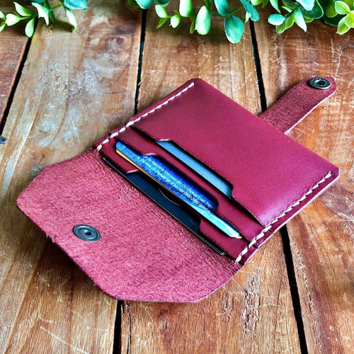 Leather Card Wallet filled with cards on a wooden background