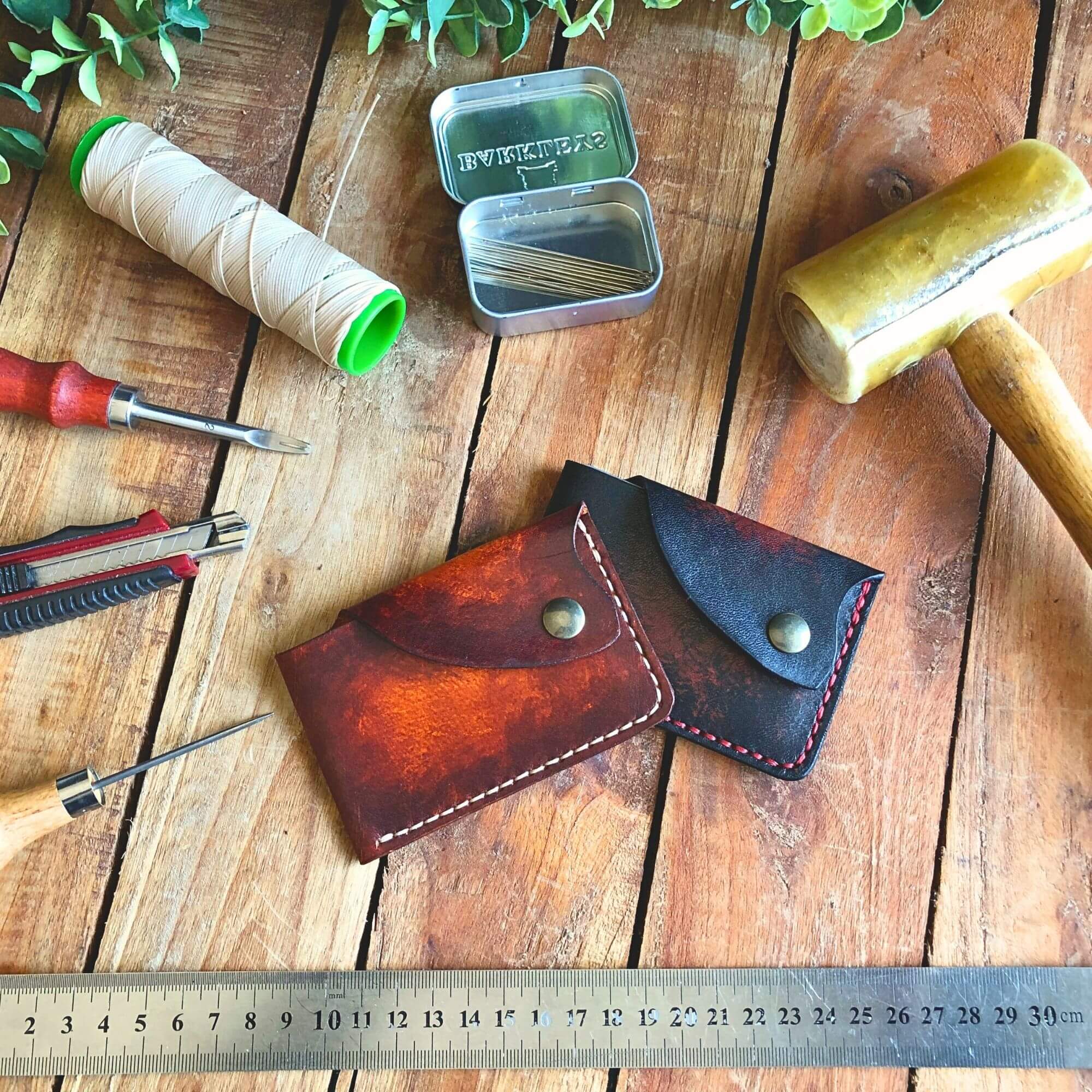 2 Leather one-piece card wallet with tools on a wooden surface