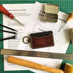 leather keychain card wallet on a printed leathercraft pattern surrounded by leathercraft tools