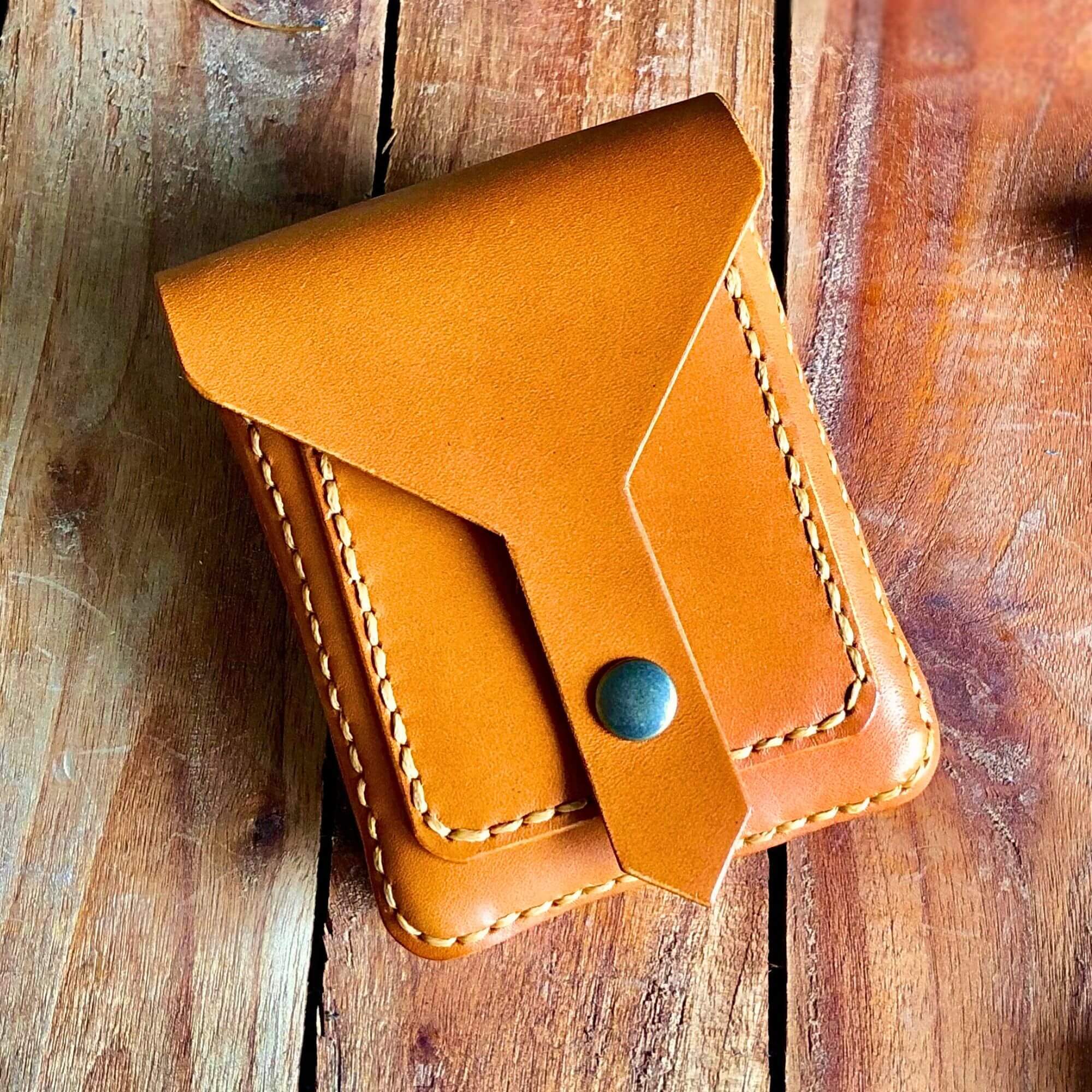 light brown leather belt bag on a wooden background