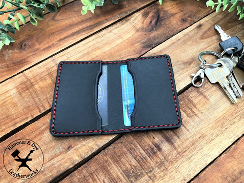 Handmade Black Bifold Leather Card Wallet on a desk next to some keys