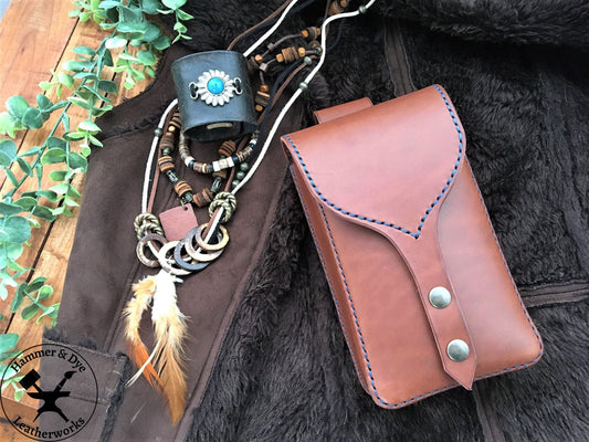 Handmade Brown Leather Festival Belt Pouch with Blue Stitching  next to some festival outfit accessories